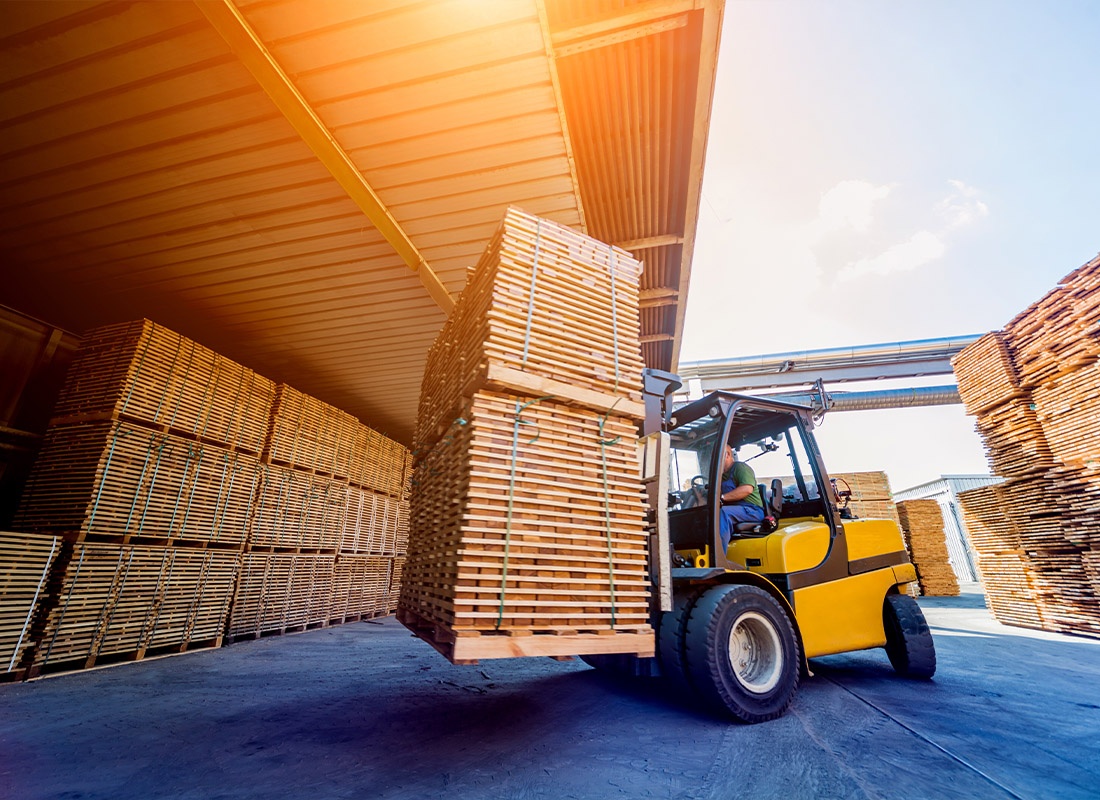 Insurance by Industry - Forklift Loader Loading Lumber Into a Dry Kiln